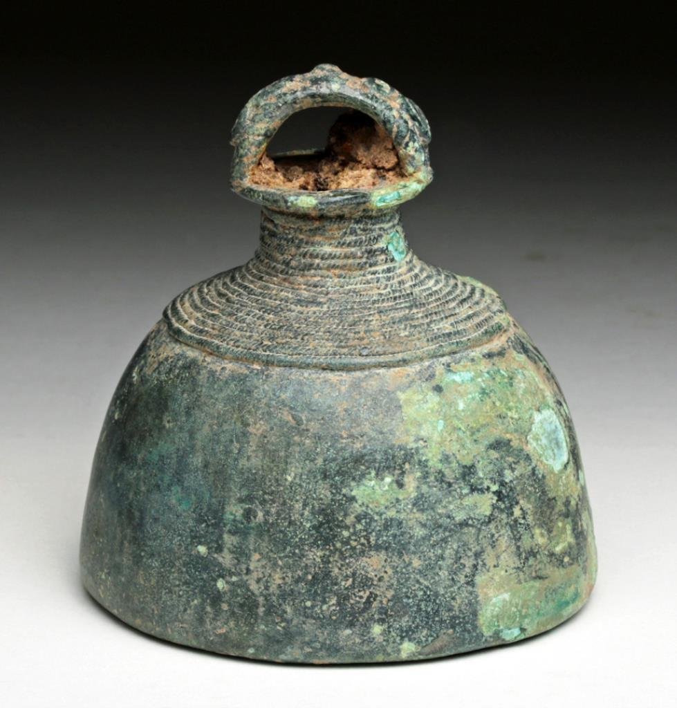 Khmer Bronze Bell: Cambodia, Ca 12th century. Lovely cast bronze bell, decorated with rope design along upper 1/3, scroll on bale. Iron clapper is rusted and stuck to interior walls with deep encrustations. Lovely patin