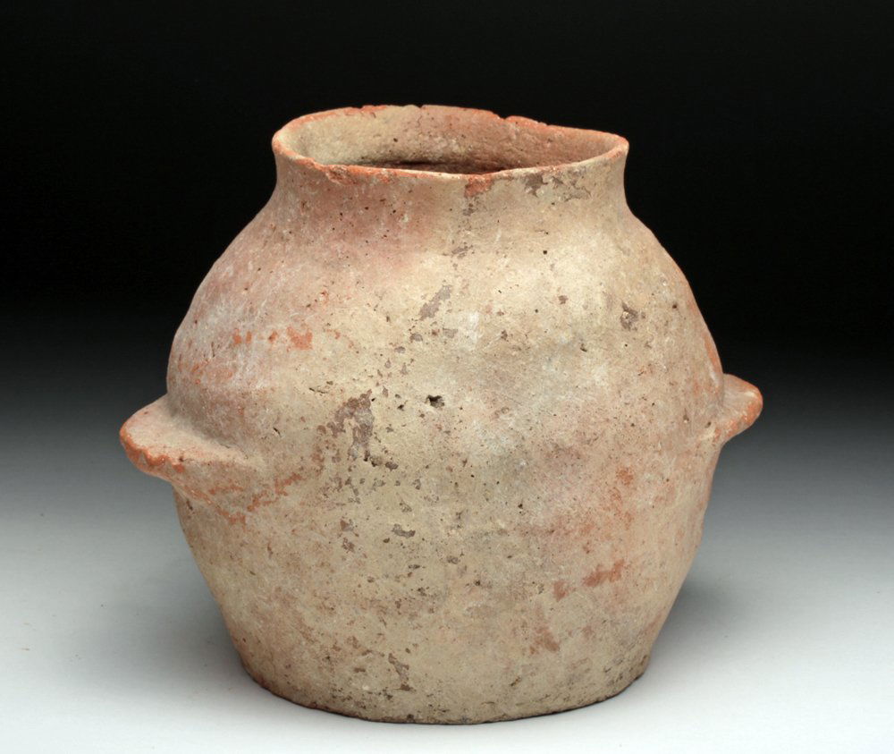 Early Bronze Age Pottery Jar, ex-Barakat: Jericho, Israel, Ca 3300 to 2700 BCE. Large pottery jar, used for storing grains in the average household. Redware vessel with short rim and twin wings to the sides. Form shows it was definitely not w