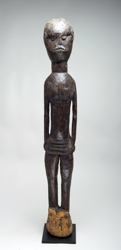 Tall Indonesian Wood Ancestor Figure: Sumba, Indonesia, ca. 20th century CE. Tall standing figure of a Sea Spirit with great patina; large and powerfully carved in wood representing an original Ancestor. Some are used as agricultural guar