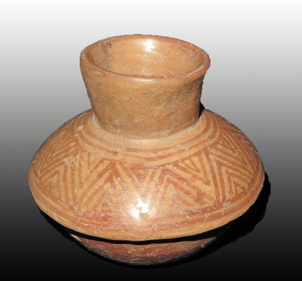 Pre-Columbian Bichrome Jar: Colima, W. Mexico, Ca 300 BCE to 300 CE. Attractive pottery jar with sloping faux lid and flared rim, painted in orange over lighter orange in chevron design. 5" wide Provenance: Ex-Lynn Langdon colle