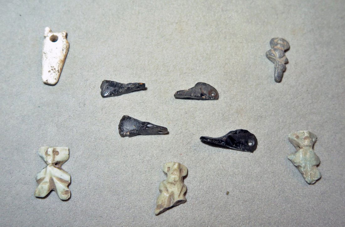 Pre-Columbian Duck Head and Figural Pendants: Nayarit, Mexico, Ca 300 BCE/1300 CE. Cute collection of 4 obsidian pendants each in the form of a duck head, and each drilled for suspension. Along with 5 stone pendants in human form. 2 to 3 cm long.