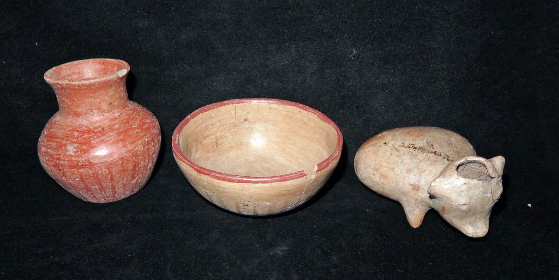 Three Pre-Columbian Vessels - West Mexico: Colima and Nayarit Mexico, Ca 300 BCE/CE. First, cute pottery dog in light orange slip. 5 1/2" long. Next, redware jar with burnished stripes. 3-3/4" H. Finally, orangeware bowl with red rim and burni