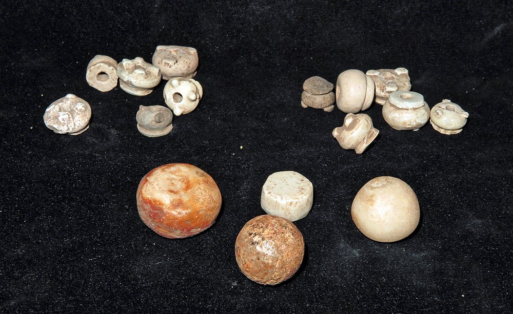 12 Pre-Columbian Stone Whorls and 4 Stone Discs: Ixcuintla Phase, Nayarit area, W. Mexico, Ca 1000 to 1300 CE. 12 stone spindles whorls, all in the form of 3 or 4 legged pots. 3/16" to 5/8" wide. Along with 4 stone discs/balls, possibly representing