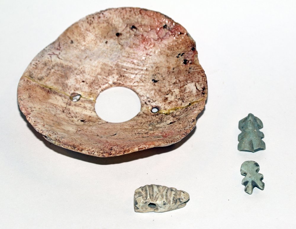 Lot of 3 Pre-Columbian Stone Pendants + Shell Pectoral: West Mexico, Ca 300 BCE/CE. Interesting and large shell pectoral in circular form, drilled twice for suspension. 3-1/4"D. Along with three pendants. First is in the form of a lizard head; 1" long. Alo