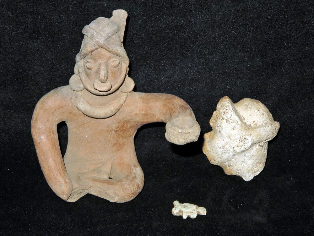 Jalisco Seated Figure Holding Cup + 2 more: Pre-Columbian, Jalisco, Mexico, Ca 300 BCE/CE. First, seated pottery figure, legs crossed holding cup in left hand, wearing full battle gear. 6 1/4" tall. Next, small stone carving of an animal. 1-1/8