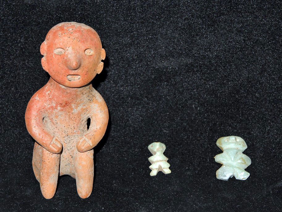 Pre-Columbian Seated Figure + 2 Figural Pendants: Colima, W. Mexico, ca. 300 BCE to 3000 CE. Included in this lot are a 3-1/2" seated redware figure, a 24 mm tall stone figural pendant with perforated neck for suspension, and a 16 mm stone pendant wi