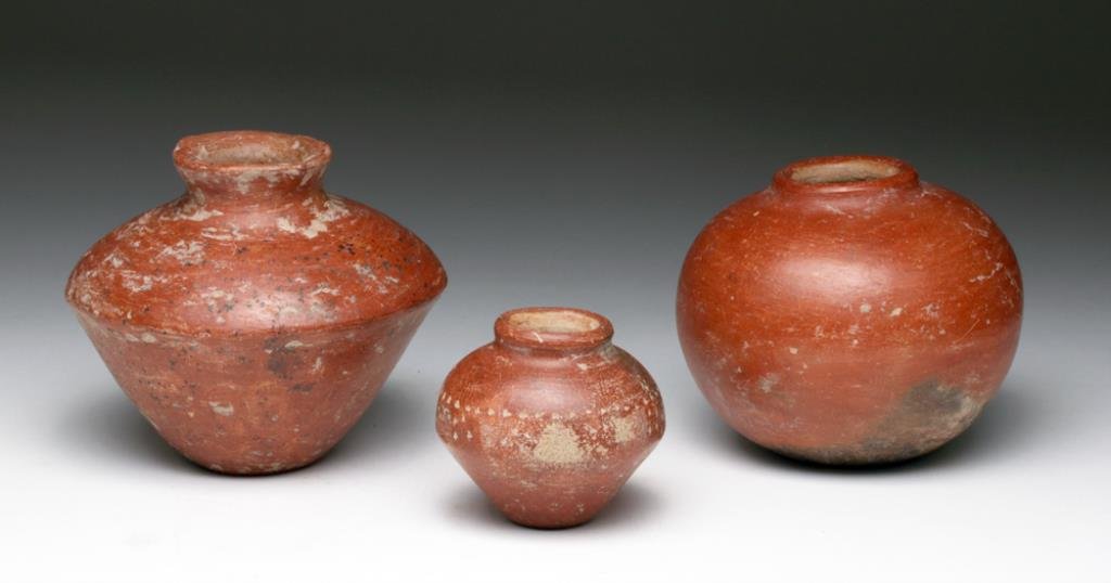 Lot of 3 Colima Redware Jars: Pre-Columbian, West Coast, Mexico, Ca 300 BCE to 300 CE. Another group of fine pottery items! Three smallish pottery seed jars, two in piriform shape, other very rounded. The two piriform shaped jars