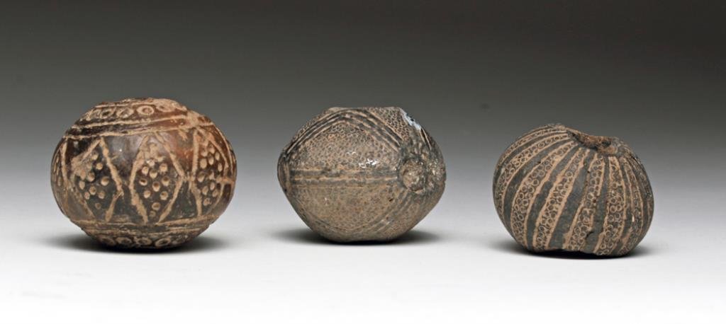 Lot of 3 Very Large Pre-Columbian Spindle Whorls: West Mexico, Ca 300 BCE to 300 CE. Three pottery spindle whorl beads, each in deep brown to black and extensively decorated with incised geometric patterns. 1-3/4" D for largest. Provenance: Ex-privat