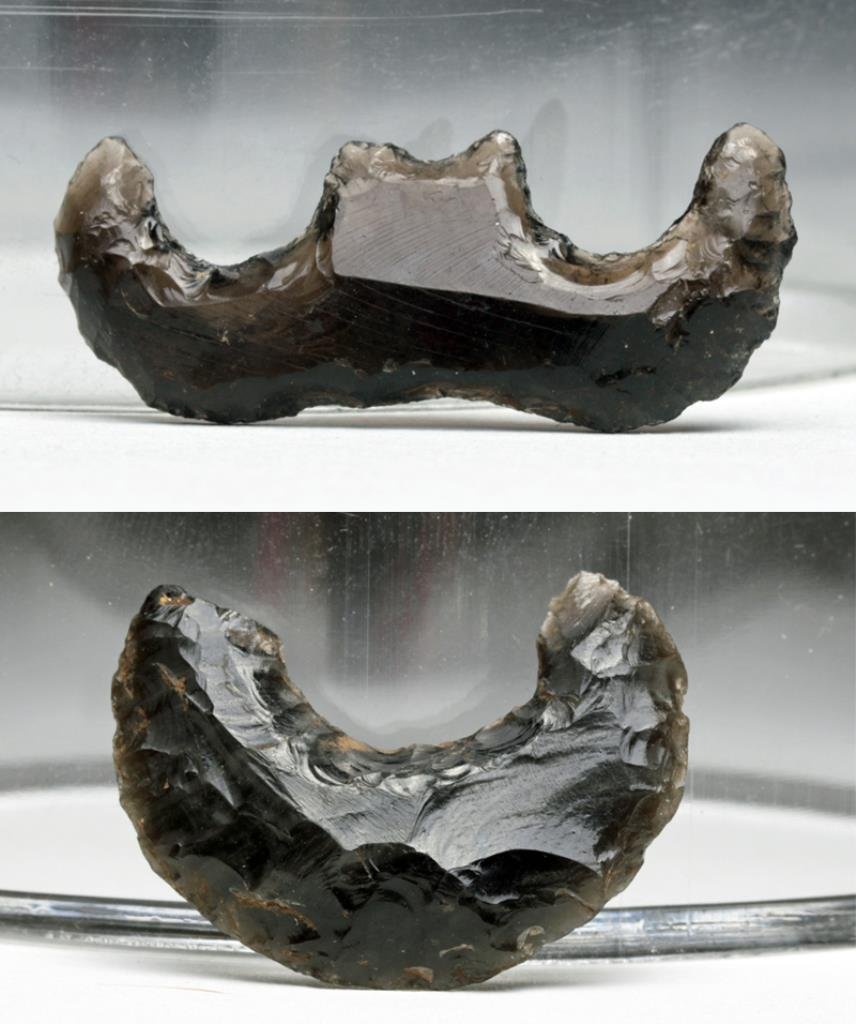 Lot of 2 Pre-Columbian Obsidian "Eccentrics": Colima, Mexico, Ca 300 BCE/CE. Two superbly knapped obsidian decorations. First is a crescent-shaped object that appears to have been created purely to show off the skill of the artisan. 1-3/8" across