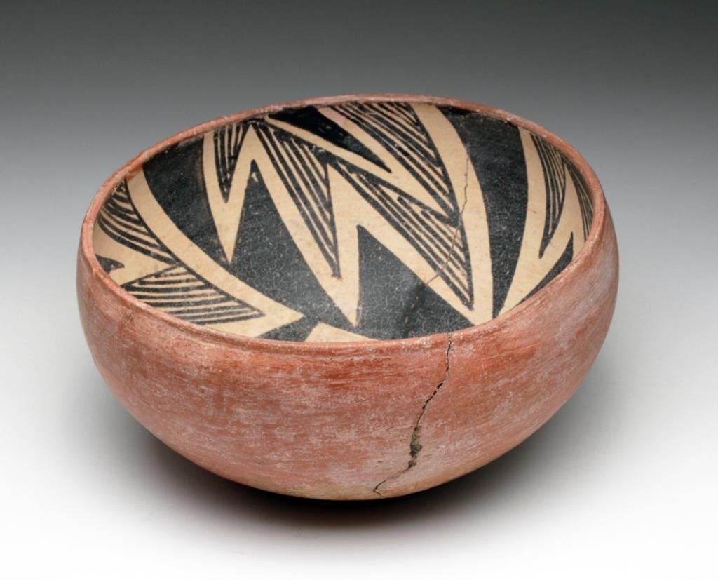 Native American Anasazi Gila Pinto Bowl: Anasazi, approximately 60 miles east of Phoenix in the Superstition Mountains. Salado Polychrome transitional Gila Pinto, Ca 1300 to 1400 CE. Stunning fine-line painted bowl in black and tan over red 