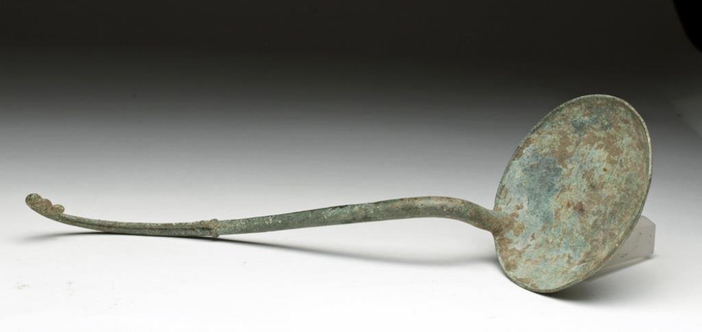 Khmer Decorated Ceremonial Bronze Ladle: Cambodia, Khmer period, Ca 12th century CE. Lovely and choice bronze ladles with sweeping handle terminating at one end with shallow spoon, graceful scroll at other. 11-1/4" L. Provenance: Ex Private 