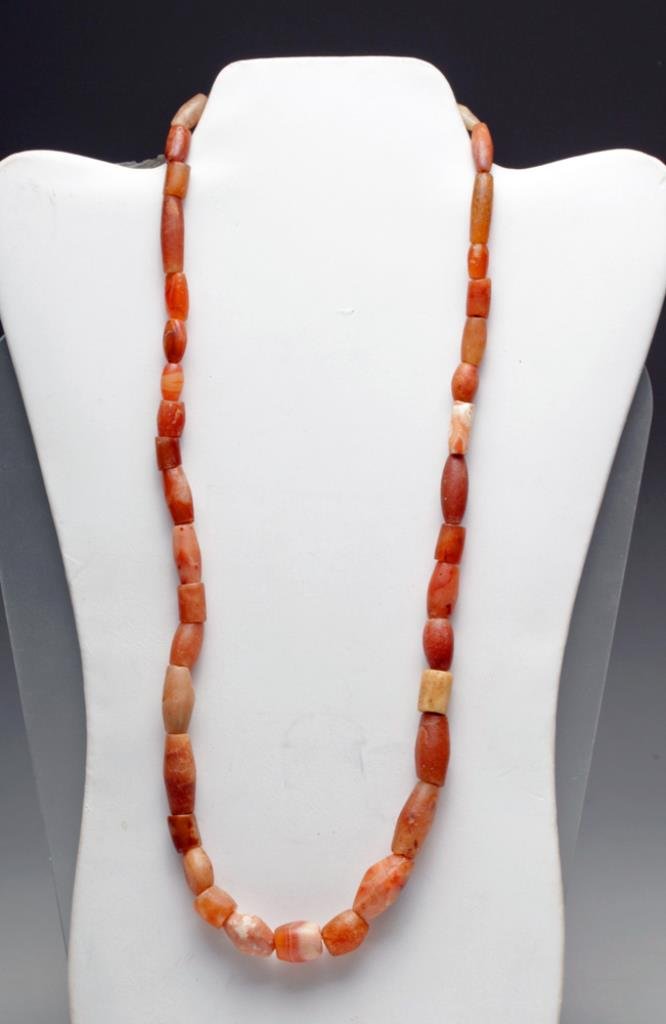 Bactrian Necklace of Carnelian Stones: Bactrian culture, Pakistan, Afghanistan, Ca 1st millennium BCE. A very beautiful necklace comprised of stones primarily in the red and brown family, with quartz crystal, carnelian and agates, some fac