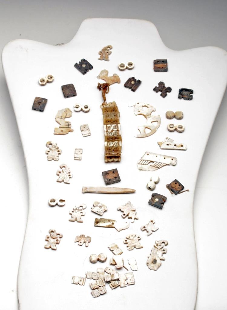 Large Collection of Chimu Inca Shell Beads: Northern Peru, Ca 1000 to 1500 CE. A large and rare cache of carved shell beads, some still in the bracelet form that was worn over 600 years ago. Includes figural and geometric beads of various sizes