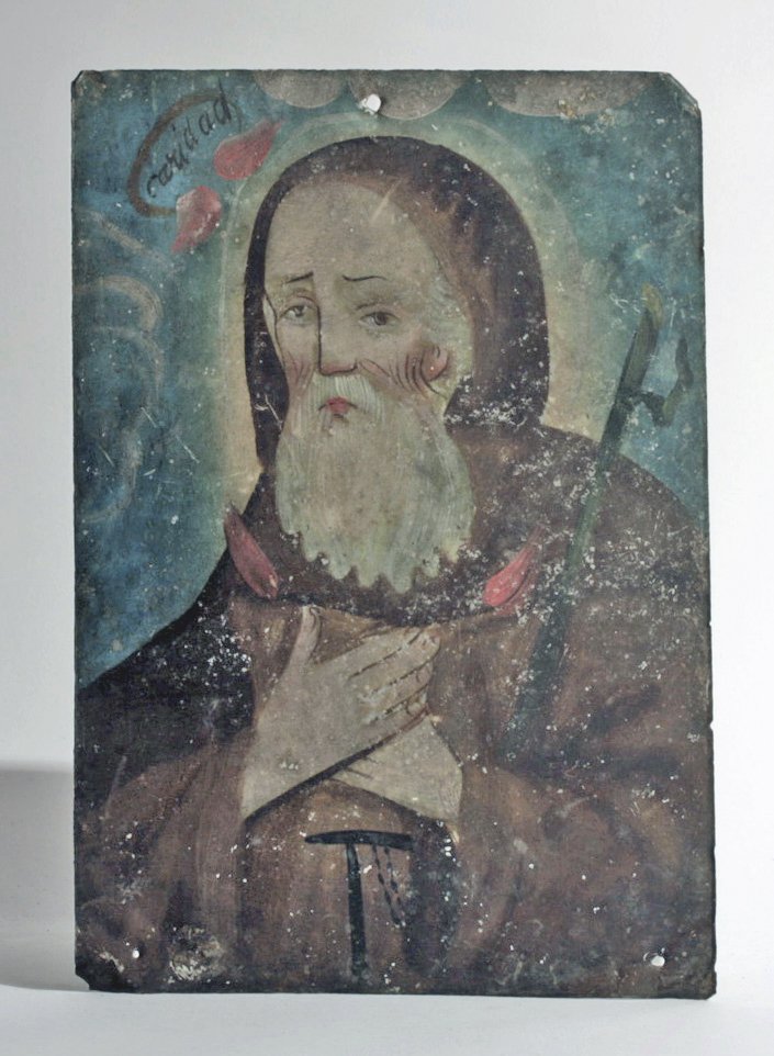 19th C. Mexican Retablo, San Francisco De Paula: Mexico, ca. 19th Century CE. An antique tin retablo depicting St. Francis of Paolo shown here wearing the simple robes of his order, his hands crossed on his chest. His face is lined with age, his bro