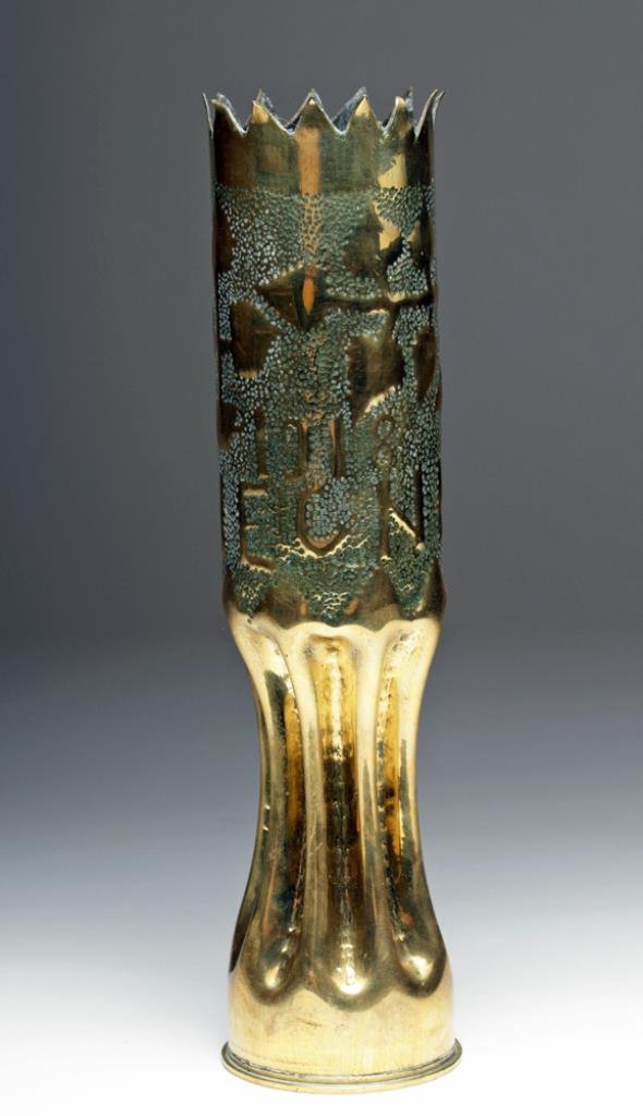 Another Fabulous WWI Trench Art Shell: France, Ca 1918. Trench art artillery shell converted into a lovely yet somber reminder of the Great War. Large 75mm shell with pinched power section, upper area with "pecked" design of laurel or ivy