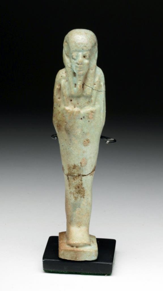 Egyptian Green Faience Ushabti: Egypt, Late Dynastic Period, Dynasties 26 to 30, Ca 662 to 330 BCE. Standing mummiform servant for the deceased, hands held to the chest holding crook and flail. 4-3/4" H. Provenance: ex-European coll