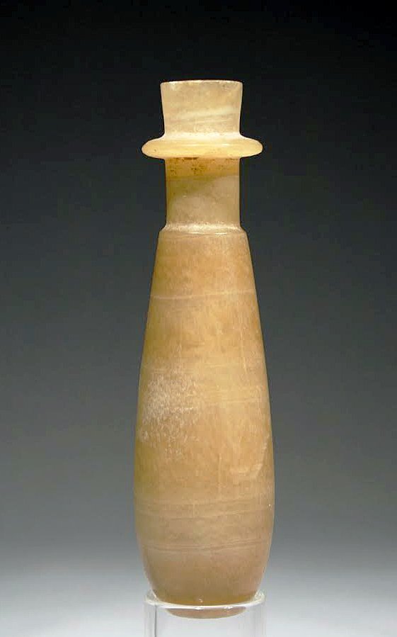 Egyptian Calcite Alabaster Slender Bottle: Egypt, Late Period . 6th-4th cent. B.C. Elongated, pear-shaped body with small base, profiled neck and projecting ring. Exterior polished, interior smooth, thin wall. 5"H (12.7 cm) Provenance: Formerl
