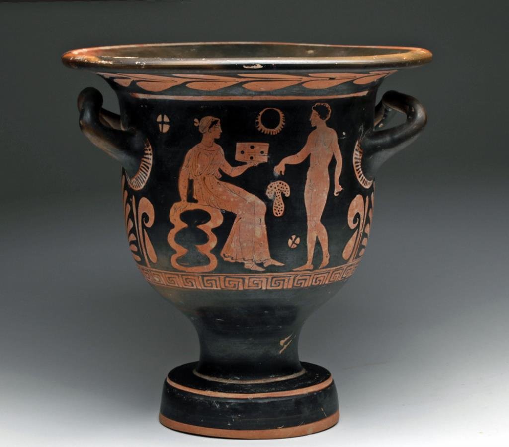 Greek Apulian Bell Krater: Southern Italy, Apulia, Ca 340 to 325 BCE. Terracotta wine drinking vessel done in red-figure technique. Side 'A' shows a seated female seated on a rock outcropping, wearing a chiton holding a cask in