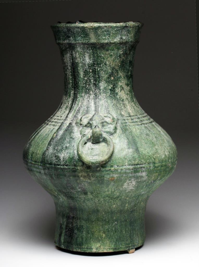 Chinese Han Dynasty Green-Glazed Hu: China, ca. 206 BCE - 220 CE. A fine large example of a green-glazed wine ewer, with cylindrical base that tapers to a wide body, and back to a slightly flared cylindrical neck. On either side of vesse