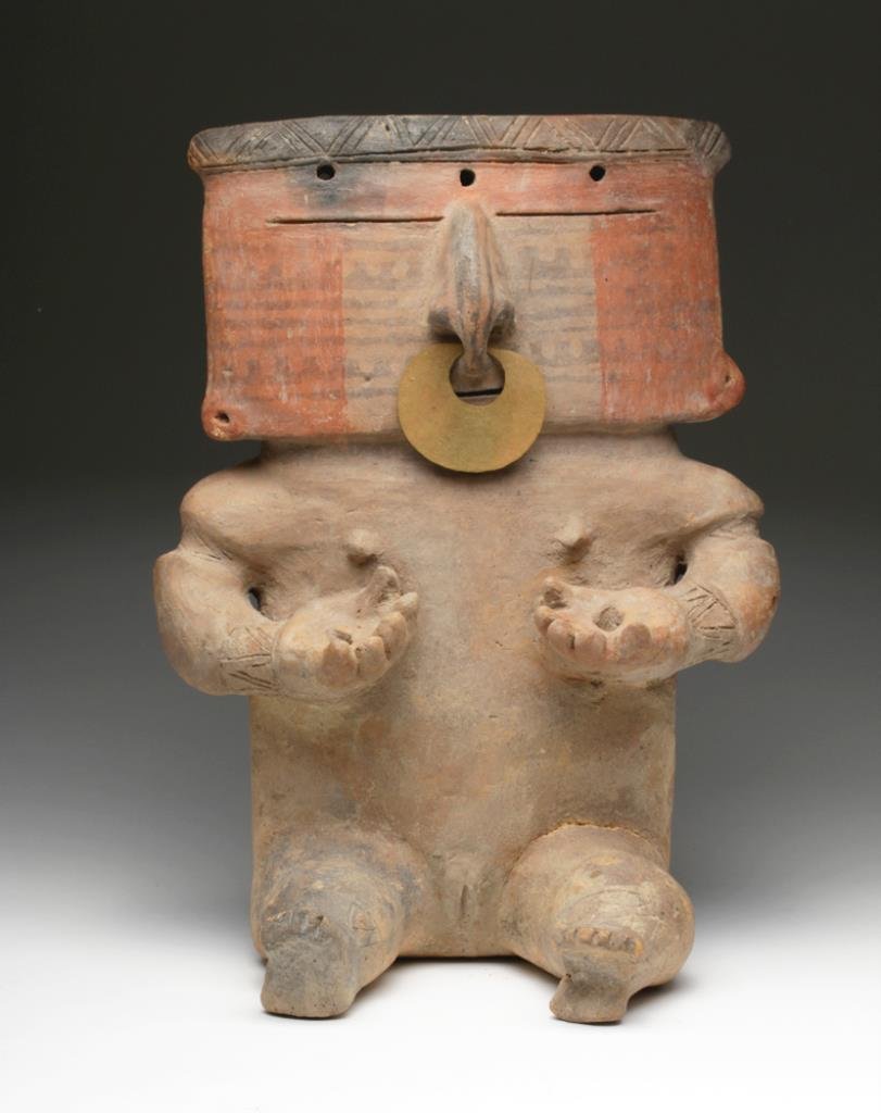 Quimbaya Polychrome Slab Figure, Gold Nose Ring: Pre-Columbian, Colombia, Quimbaya, ca. 1000-1400 CE. Female figure with wonderfully colored and tattooed face, sporting ancient gold nose ring through pierced septum, large nose, slit mouth, hands hel
