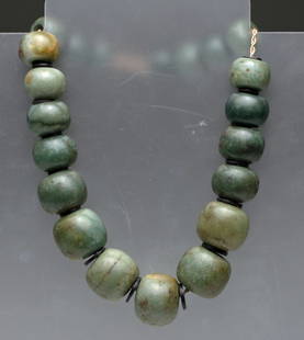 Exceptional Strand of Olmec Jade Beads, 14k Gold Chain: Olmec culture, Mexico to Guatemala, ca. 1100CE-500CE. A stunning and important strand of uniformly shaped jade beads - in graduated sizes. 21 jade beads varying in color from dark green to an