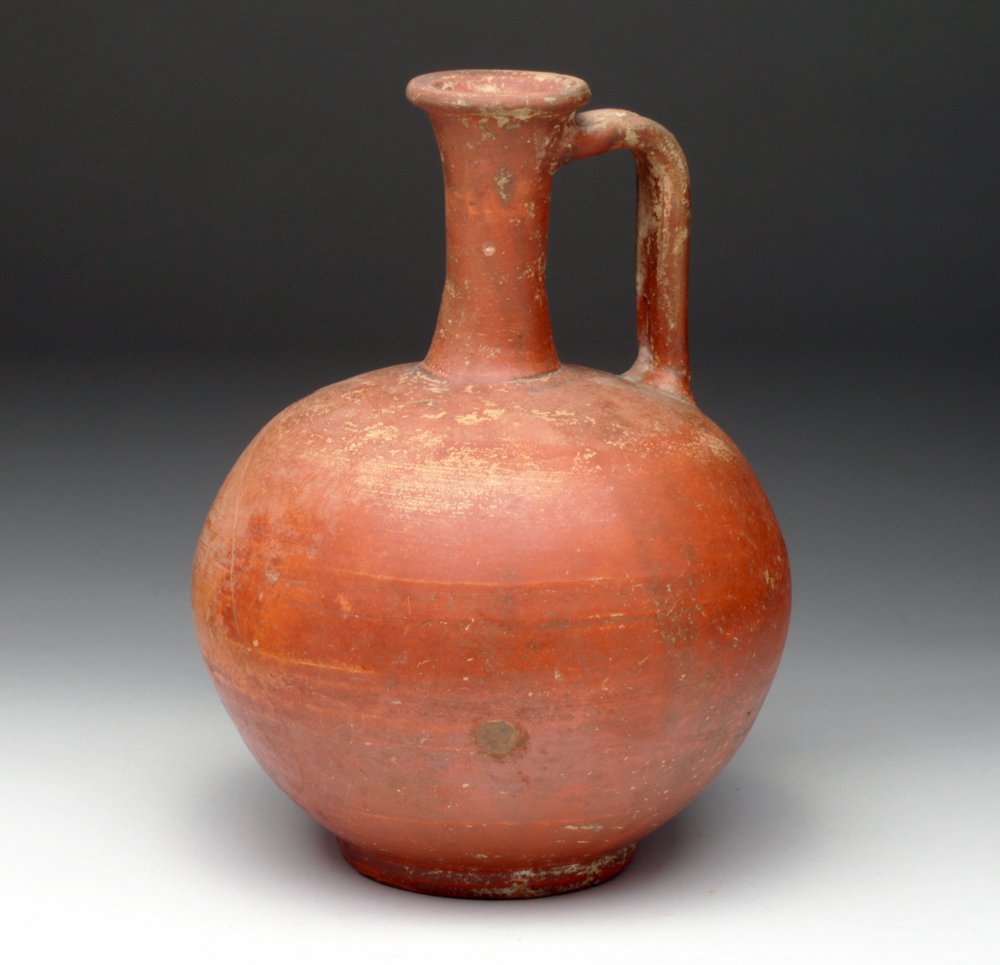 Lg. Roman Redware Pouring Vessel: Roman Empire, Ca 100 to 300 CE. Found in western Turkey. Large redware pouring vessel, with bulbous nearly-spherical base, long thin neck, flared spout and channeled handle. 8.25"W x 6.25"H (20.96 W x