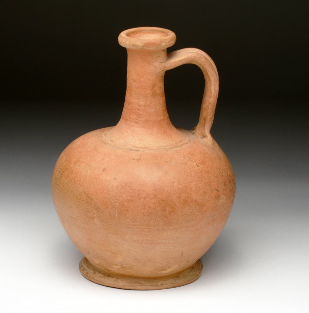 Fine Roman Redware Pouring Vessel: Roman Empire, Ca 100 to 300 CE. Found in western Turkey. Very fine redware pouring vessel, with bulbous nearly-spherical base, long thin neck, flared spout, incised rings around lower neck and ridged