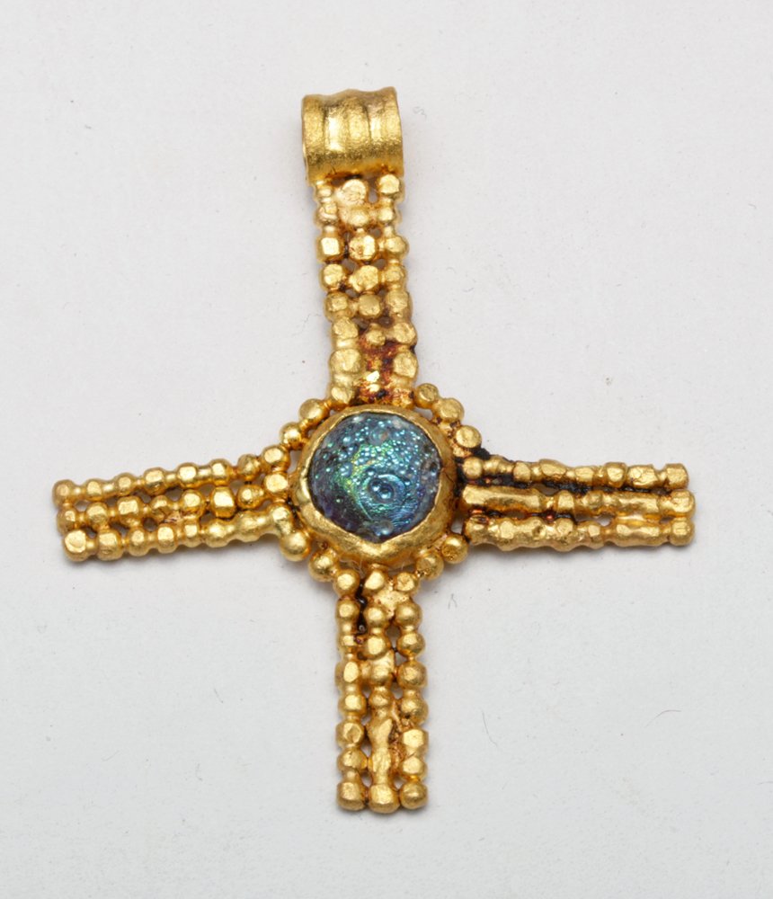 High Karat Gold Byzantine Cross w/ Glass Center: Byzantine, ca 5th to 8th century CE. Incredibly beautiful almost pure gold cross in granulated bead design set with glass center "stone" which has developed a stunning blue/green iridescence. Small su