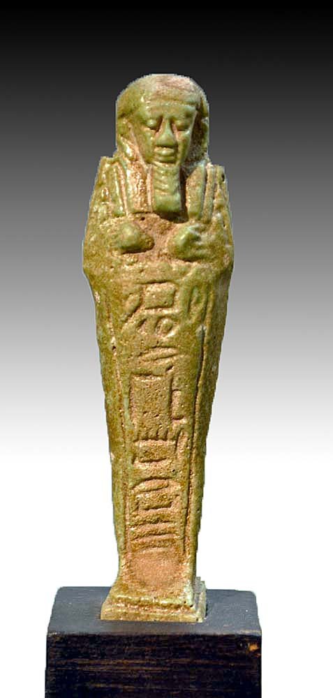 Ancient Egyptian Faience Ushabti: Egypt, Late Period, 600-30 BCE. Faience figure depicted mummiform, with prominent facial details, wearing the false beard, hands holding hoes, seed sack on back and with a vertical line of hieroglyp