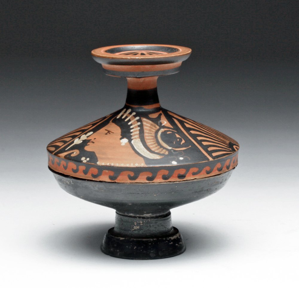 Greek Apulian Lekanis - Lady of Fashion: Greek, Apulia, southeastern Italy, Ca 325 to 300 BCE. Very fine and almost perfect pottery covered lekanis. Redware pottery with small footed lower "cup" and spooled lid, painted with the ubiquitous L