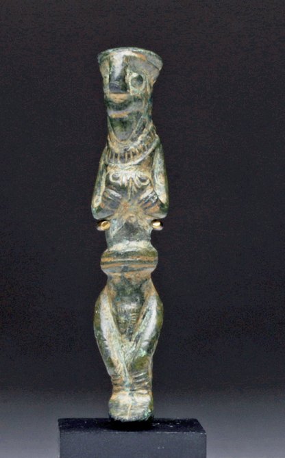 Rare Luristan Bronze Fertility Figure: Northwestern Iran, Ca late 2nd to early 1st millennium BCE. Persian / Luristan bronze cast standing figure. Very well detailed standing female, nude save necklace and sandals on her feet, hands claspi