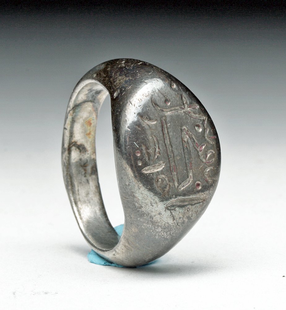Seljuk Silver Signet Ring - Horse Motif: Central Asia, Islamic, Seljuk Empire, ca. 11th - 14th century CE. A seal ring comprising a D-section hoop expanding to a discoid bezel, incised with Islamic characters and horse-head motif. This icono