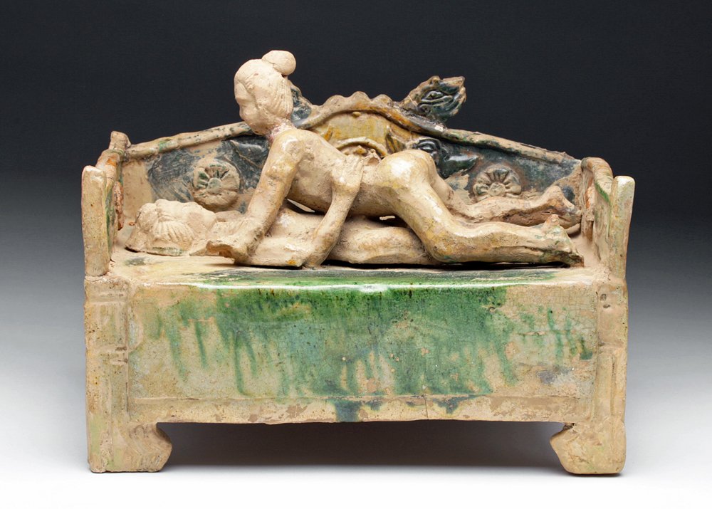 Chinese Ming Dynasty Bed w/ Lovers, Sancai Glazed: China, Ming Dynasty, ca 15th to 16th century CE. Lovely version of Chinese erotica! Terracotta bed decorated with floral elements, dragon heads and covered in green and gold glaze in a technique datin