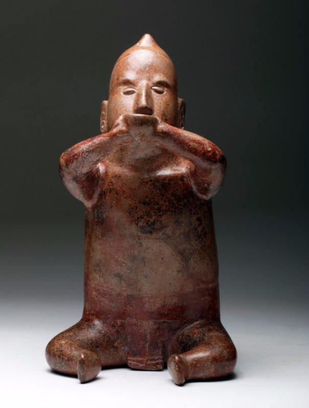 Pre-Columbian Colima Seated 'Drinker' Figure: Pre-Columbian, Colima, West Mexico, Ca 200 BC to 200 CE. Typical 'drinker' pottery male figure seated with legs slightly bent, arms raised holding a small cup to his mouth. The horn on his headdress i