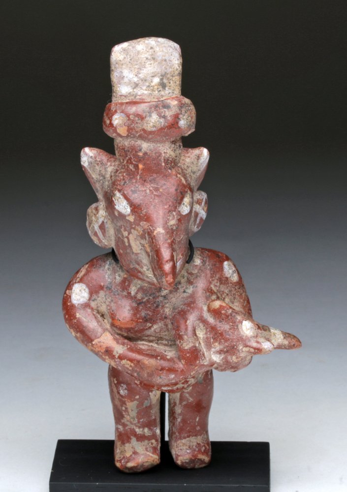 Very Fine Jalisco Sheep Face Mother & Child: Pre-Columbian, West Mexico, Jalisco region, ca 200 BCE/CE. Very attractive pottery solid molded figure of a standing mother and her child, held at her breast. In typical "sheep-faced" visage. Finely h