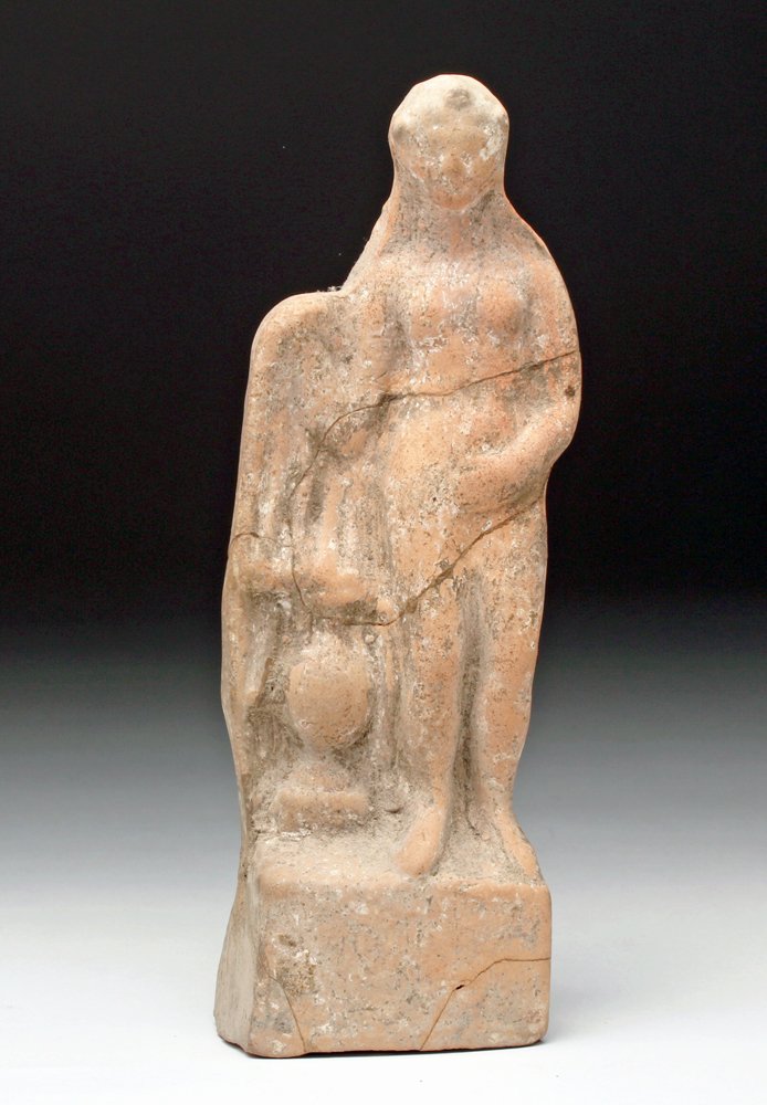 Hellenistic Greek Statuette of a Goddess: Greece, Ionia (western Turkey), ca 3rd century BCE. Statuette of goddess, nude save for cloak draped over her shoulder, amphora near her right leg. 8"W x 2-1/2"H (20.32 W x 6.35 H cm) Provenance: Ex-