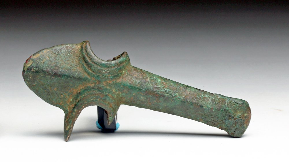 Luristan Bronze Axe - Rare Form: Iran, northwestern Persia, Ca 3rd to 2nd millennium BCE. Unusual bronze pick axe head. Smallish bronze weapon with rounded flange to one side, long rounded "pick" to other side with nicely decorated s