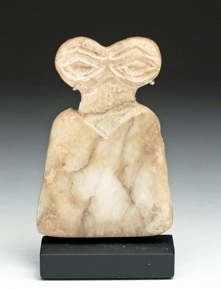 Syrian Marble Eye Idol, Tell Brak Region: Syria, Tell Brak region, ca. 3500 - 3300 BCE. Marble or alabaster of abstracted flattened form, with incised eyes and curved eyebrows, narrow neck, shoulders sloping to a broad body and flat base. Use