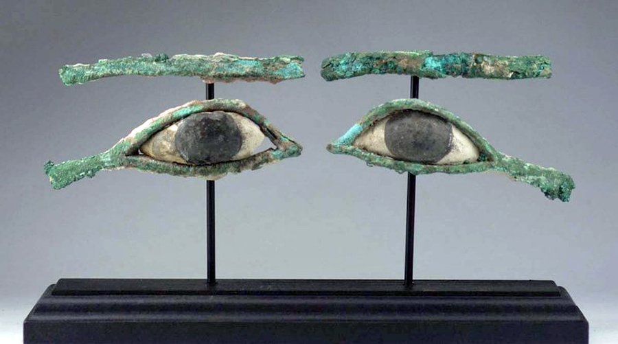 Egyptian Bronze / Stone Eyes (from a Sarcophagus): Egypt, Late Period, 26th to 30th Dynasty, 664 - 330 BCE. Nicely mounted pair of ancient bronze and limestone eyes and eyebrows. From a wooden sarcophagus mummy mask. Size: Eyes measure 4"W, Eyebrows m