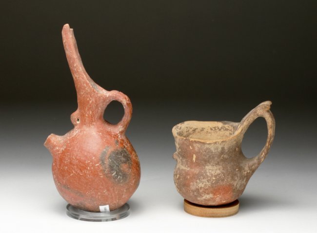 Lot of 2 Cypriot Redware Vessels: Cyprus, Middle Bronze Age, Ca 1900 to 1650 BCE. Two desirable and early vessels from this cultural revolving door. First, red polished pitcher with cutaway beak and long thin spout - a portion now mis