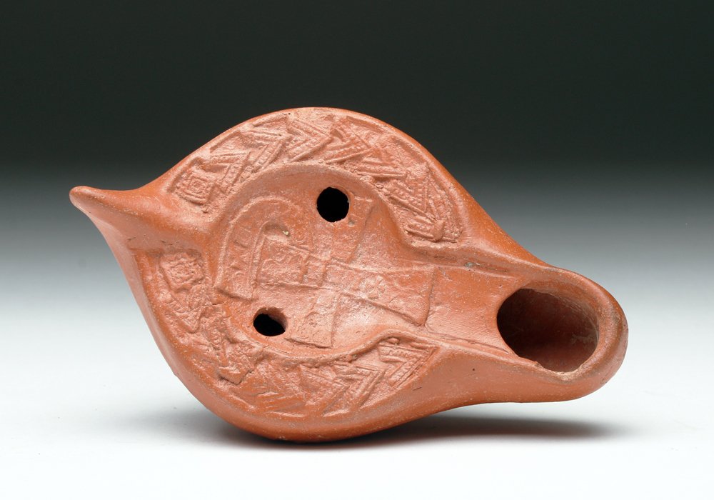 Roman Redware Chi Ro Oil Lamp: Roman Empire, Carthage, North Africa, 4th to 5th century CE. As the Christian religion began to take hold and spread throughout the Roman Empire, lamps such as these became more common and politically
