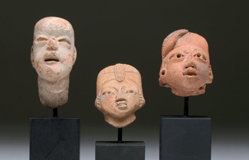 Lot of 3 Pre-Columbian Heads - Olmec + Mayan: Pre-Columbian, Southern Mexico to Guatemala, Olmec culture, ca. 1000-400 BCE. Hand-built terracotta head of Olmec baby figurine. The Olmec were noted for their baby face figurines. This is significant
