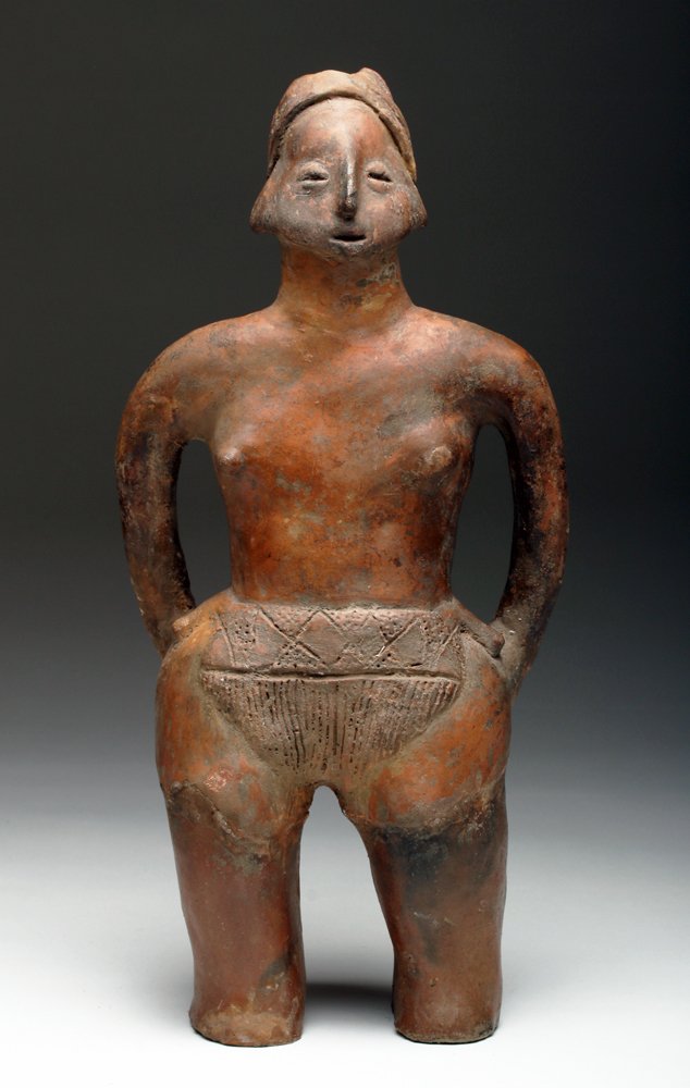 Colima / Comala Standing Redware Figure: Pre-Columbian, West Mexico, Colima, Comala Style, ca. 200 BCE - 200 CE. Standing pottery figure, nude aside from loincloth, incised with elaborate geometric decoration, and headband. The figure stands