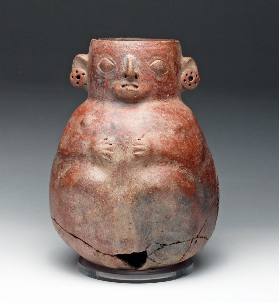 Pre-Columbian Recuay Effigy Vessel: Northern Peru, ca 200 BCE/CE. Large pottery storage jar in deep burnished redware in the shape of a seated human. Large earspools decorate the ears. Size: 11" H. Provenance: Ex-Nick Poolos / Adeon Ga