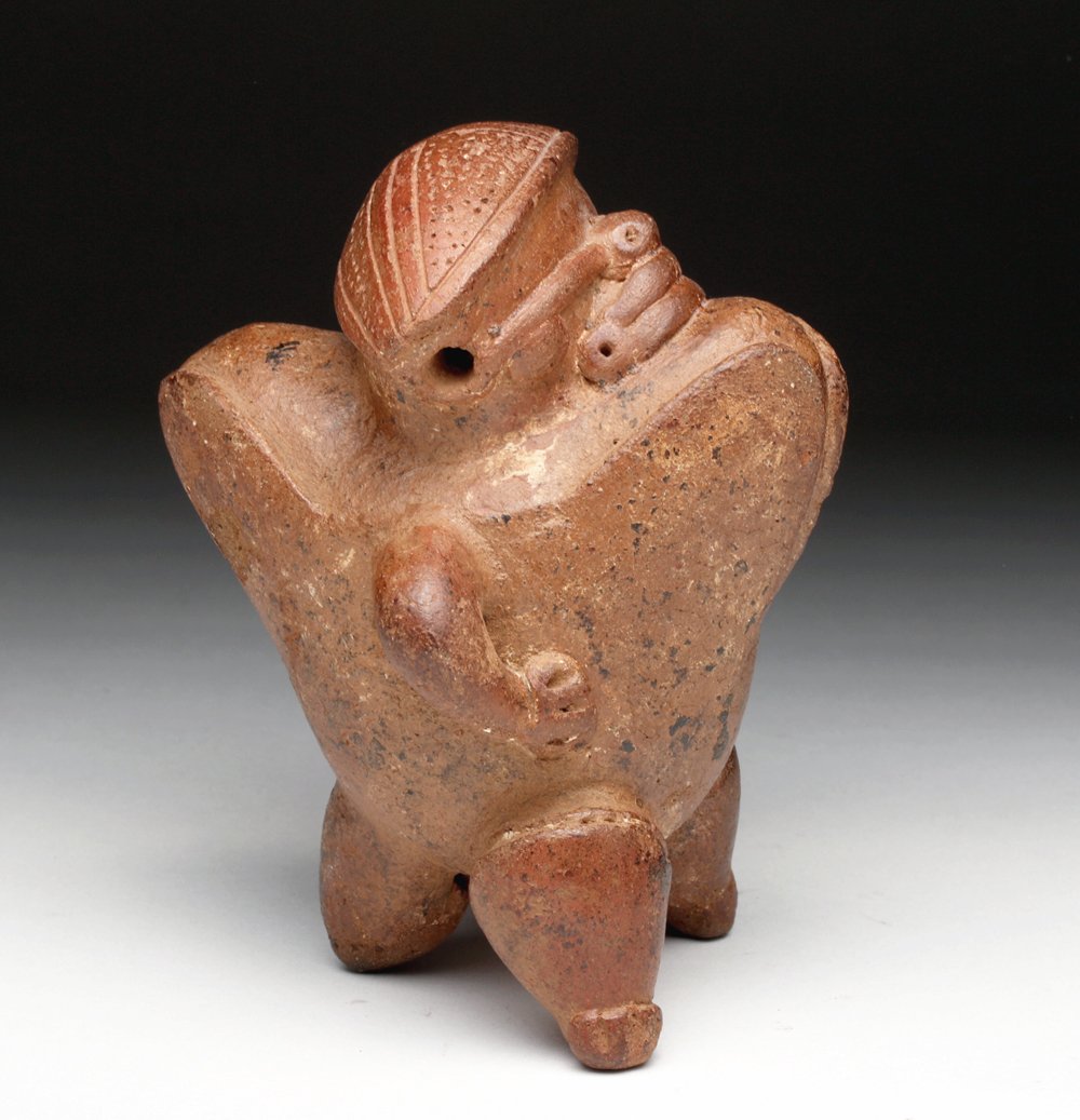 Unusual Costa Rican Standing Warrior Whistle: Costa Rica, ca 500 to 1200 CE. Very unusual pottery whistle of a standing warrior. He wears armor front and back, and a small olla in his left hand. Whistle is incorporated into rear and sound emerges