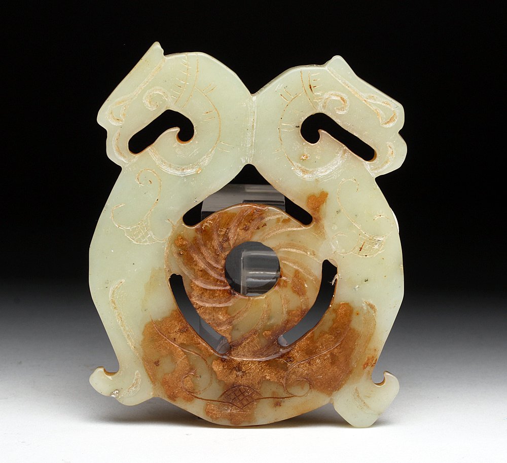 Chinese Jade Pendant, Double Bird Heads: China, Qing Dynasty to early Republic period, ca. 1900- 1925 CE. An elegant plaque carved from "mutton fat" jade with opposing birds (phoenix perhaps?), each with incised decoration. A rounded "bi" is