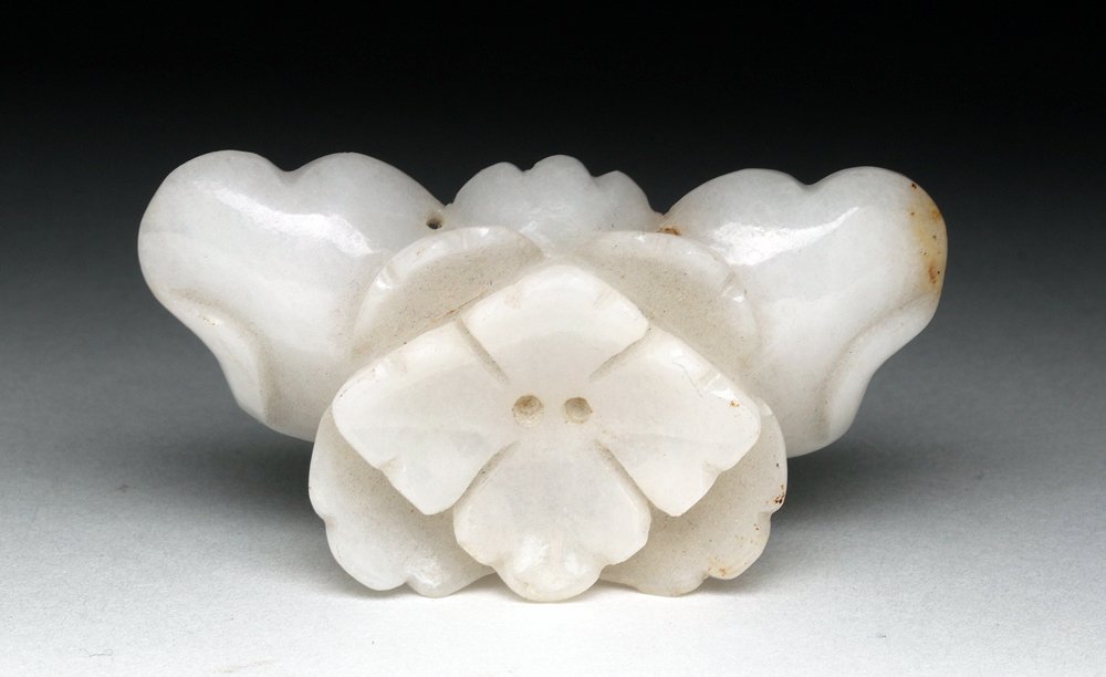 Lovely Chinese White Jade Flower: China, Qing Dynasty to early Republic, ca. 1900 CE. Gorgeous white jade attachment in the form of a flower - suspension holes along edges. Size: 2-1/4" W. Provenance: Ex-Sarkisian Gallery, Denver, ac