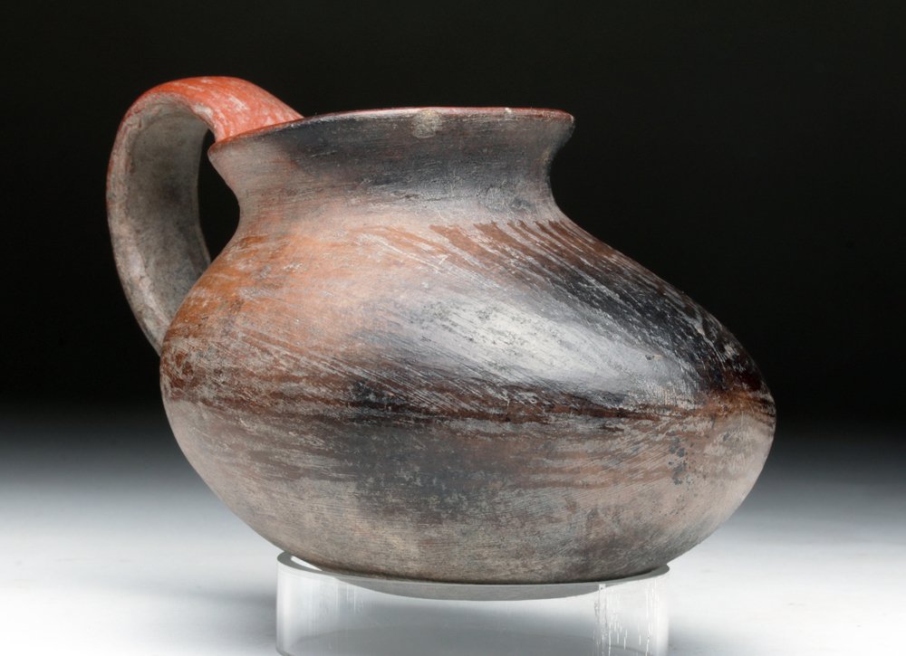 Pre-Columbian Olla - Foot Shape: Mexico, Michoacan area, ca. 300 BCE/CE. Almost perfect pottery olla or dipper in the form of a rounded human foot - or possibly a native gourd. Finished in red and brown slip which was then painstakin