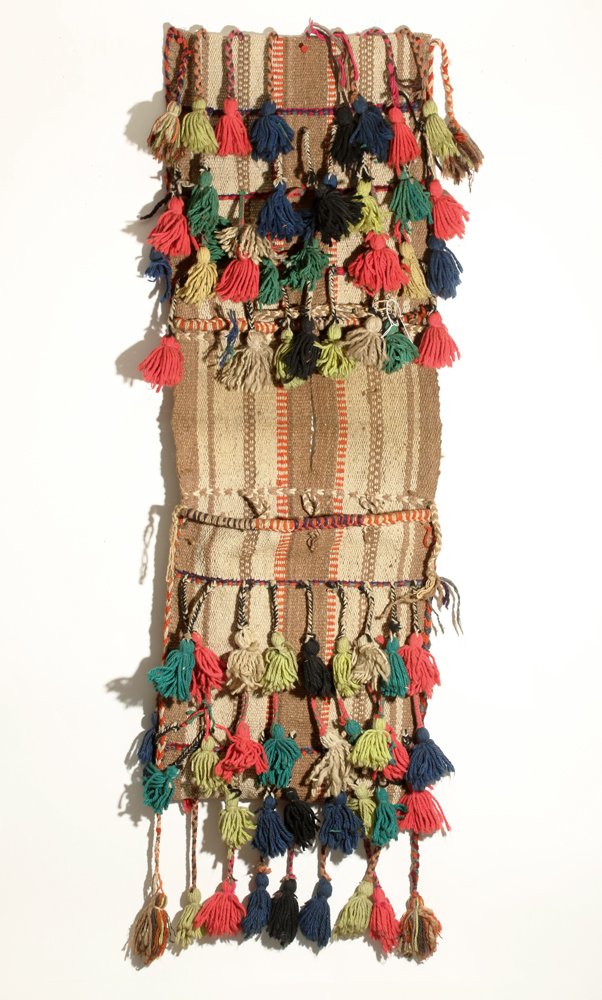 20th C. Near Eastern Woven Camel Blanket: Iraq, middle of 20th century CE. Woven camel blanket in shades of brown, ornage and tan with numerous applied tassles in red, green, blue, tan and yellow. Attractive wall art! Size: 48" L. Provenance: