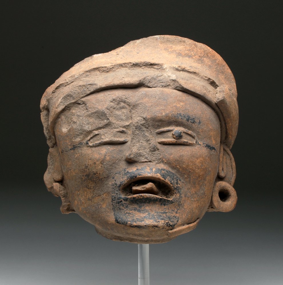 Lg. Pre-Columbian Veracruz Head: Mexico, ca. 400 to 600 CE. Vera Cruz example with expressive visage highlighted with black bitumen, large ear spools and headdress. Size: 8" H. Provenance: Ex-G. Martin collection acquired in the 1990